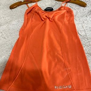 LIGHT ORANGE BEBE BRAND CAMI TOP. SIZE P/S - P/P USED. GOOD CONDITION.